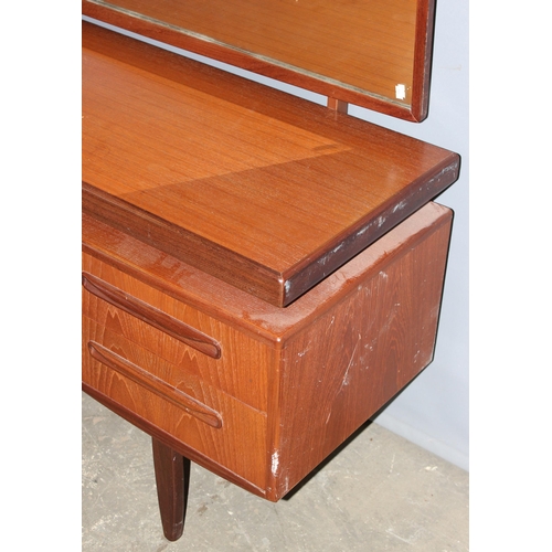 17 - A retro G-Plan tea dressing table with mirror and 4 drawers, approx 152cm wide x 46cm deep x 150cm t... 