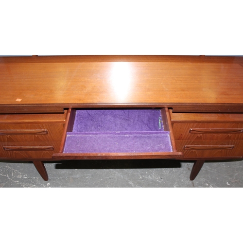 17 - A retro G-Plan tea dressing table with mirror and 4 drawers, approx 152cm wide x 46cm deep x 150cm t... 