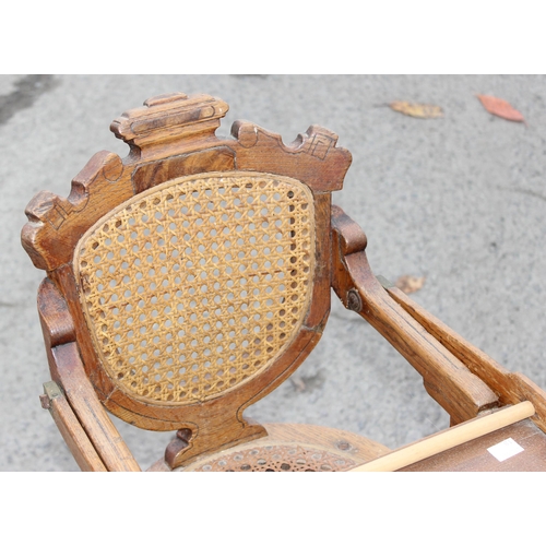 20 - An antique oak bergere seated child's high chair, approx 90cm tall