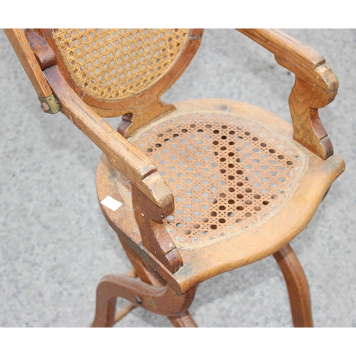 20 - An antique oak bergere seated child's high chair, approx 90cm tall