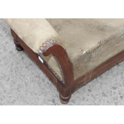 42 - A walnut and rosewood gout stool, the shaped upholstered foot rest on double ratchet height adjustab... 