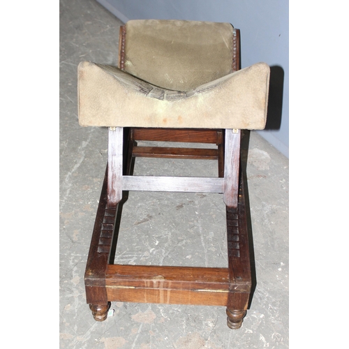 42 - A walnut and rosewood gout stool, the shaped upholstered foot rest on double ratchet height adjustab... 