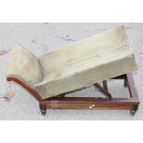 42 - A walnut and rosewood gout stool, the shaped upholstered foot rest on double ratchet height adjustab... 