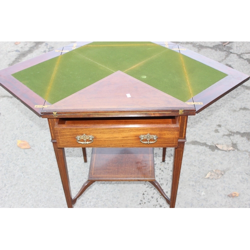 13 - A late 19th or early 20th century mahogany envelope card table with undertier, the top twists to ope... 