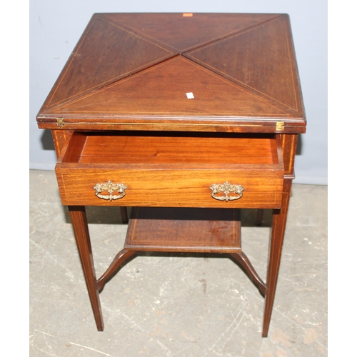 13 - A late 19th or early 20th century mahogany envelope card table with undertier, the top twists to ope... 