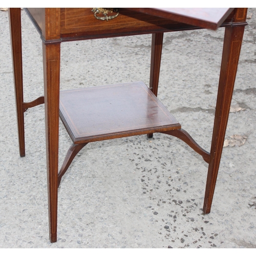 13 - A late 19th or early 20th century mahogany envelope card table with undertier, the top twists to ope... 