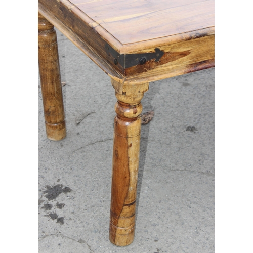 43 - A modern striated Indian hardwood dining table with iron accents, approx 179cm wide x 90cm deep x 77... 