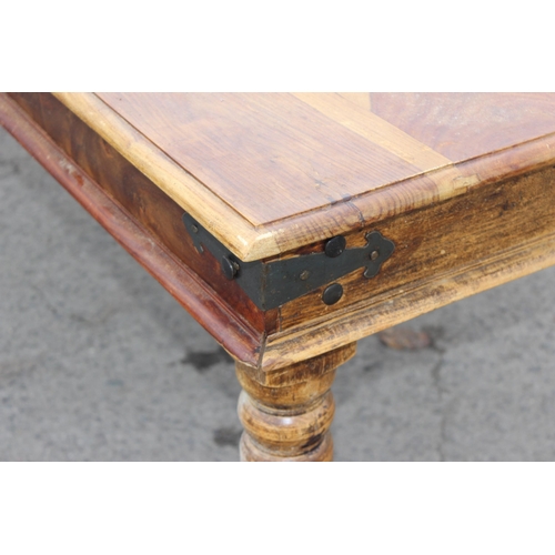 43 - A modern striated Indian hardwood dining table with iron accents, approx 179cm wide x 90cm deep x 77... 