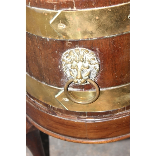 11 - A George III mahogany oval and brass bound wine cooler, circa 1780, now as a jardiniere, with lions ... 