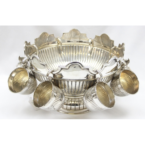 1001 - A large vintage silver plated punchbowl and 8 cups with half gadrooned design and a wavy crenelated ... 