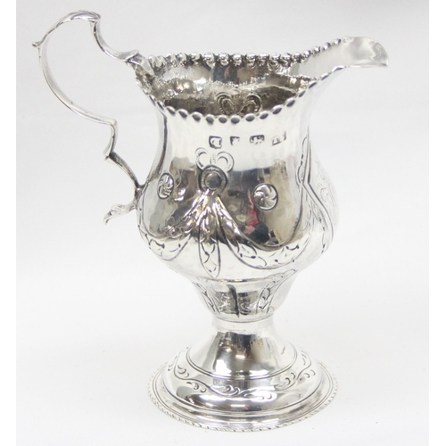 1002 - A George III period silver cream jug with embossed decoration, London 1774 by Thomas Shepherd, appro... 