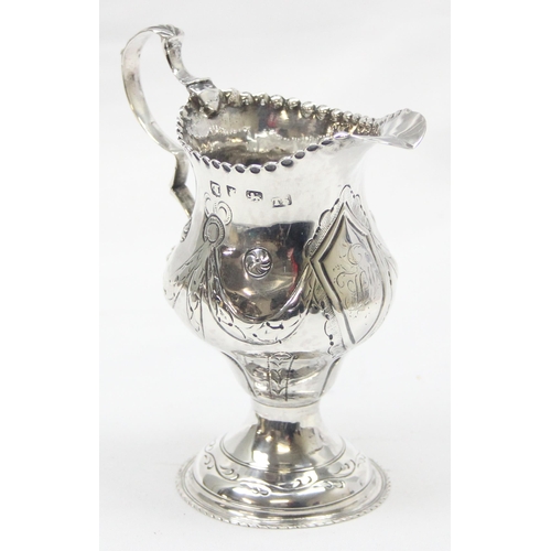 1002 - A George III period silver cream jug with embossed decoration, London 1774 by Thomas Shepherd, appro... 