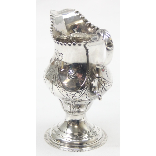 1002 - A George III period silver cream jug with embossed decoration, London 1774 by Thomas Shepherd, appro... 