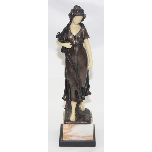 1655 - In the manner of Peter Tereszczuk (1875-1963), a vintage bronzed spelter figure of a lady with flowe... 