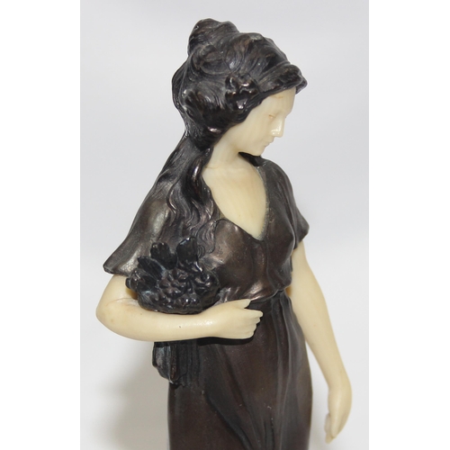 1655 - In the manner of Peter Tereszczuk (1875-1963), a vintage bronzed spelter figure of a lady with flowe... 