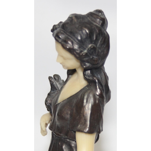 1655 - In the manner of Peter Tereszczuk (1875-1963), a vintage bronzed spelter figure of a lady with flowe... 