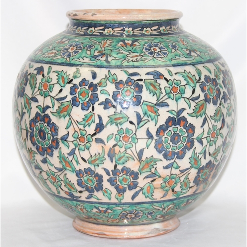 1656 - A Middle Eastern Iznik earthenware ovoid vase, decorated in the Islamic taste, with reserves of flow... 