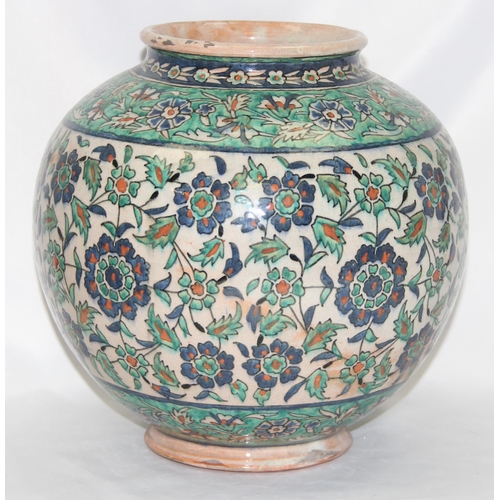 1656 - A Middle Eastern Iznik earthenware ovoid vase, decorated in the Islamic taste, with reserves of flow... 