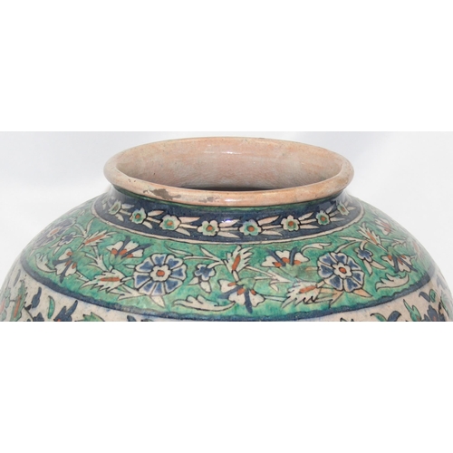 1656 - A Middle Eastern Iznik earthenware ovoid vase, decorated in the Islamic taste, with reserves of flow... 