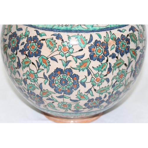 1656 - A Middle Eastern Iznik earthenware ovoid vase, decorated in the Islamic taste, with reserves of flow... 