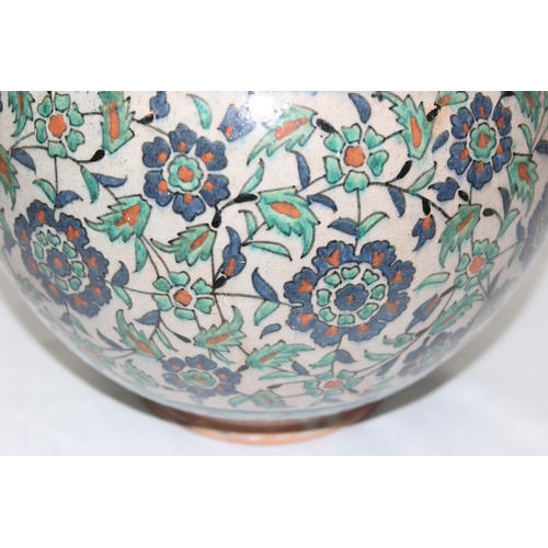 1656 - A Middle Eastern Iznik earthenware ovoid vase, decorated in the Islamic taste, with reserves of flow... 