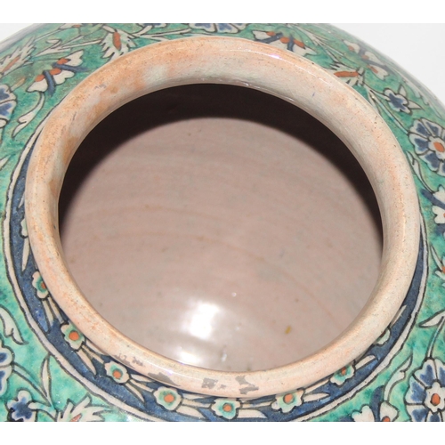 1656 - A Middle Eastern Iznik earthenware ovoid vase, decorated in the Islamic taste, with reserves of flow... 