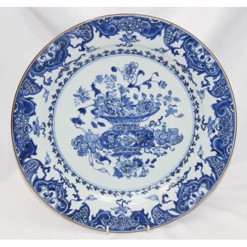 1657 - A large antique Chinese blue and white porcelain charger decorated with a scene of flowers and vases... 