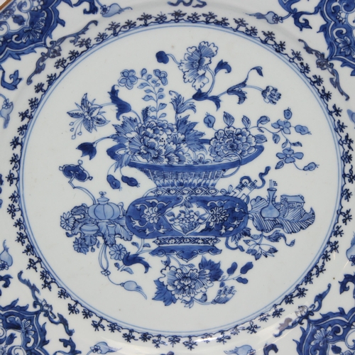 1657 - A large antique Chinese blue and white porcelain charger decorated with a scene of flowers and vases... 