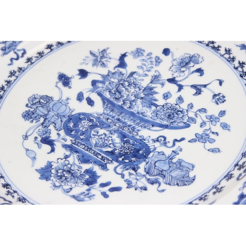 1657 - A large antique Chinese blue and white porcelain charger decorated with a scene of flowers and vases... 