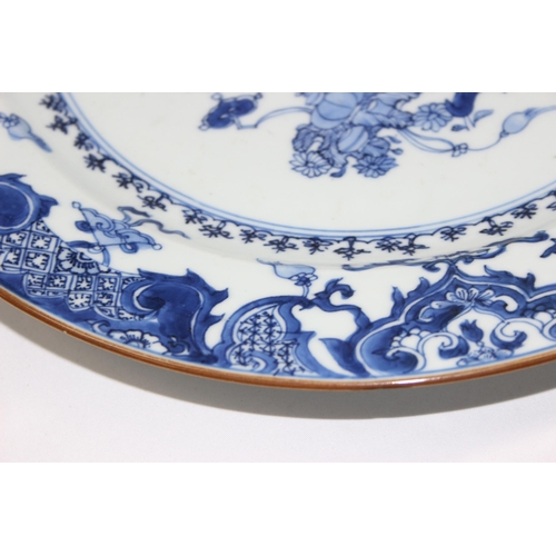 1657 - A large antique Chinese blue and white porcelain charger decorated with a scene of flowers and vases... 