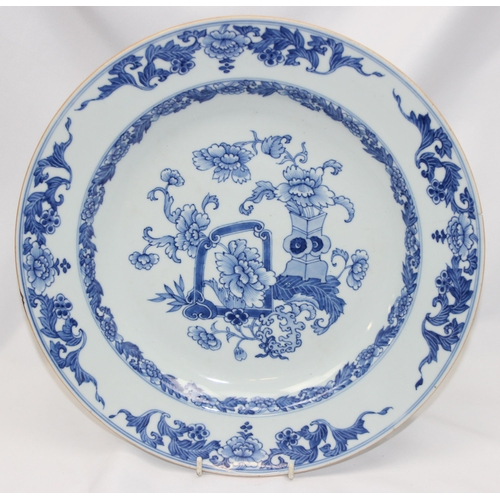 1658 - A large antique Chinese blue and white porcelain charger decorated with a scene of flowers and vases... 