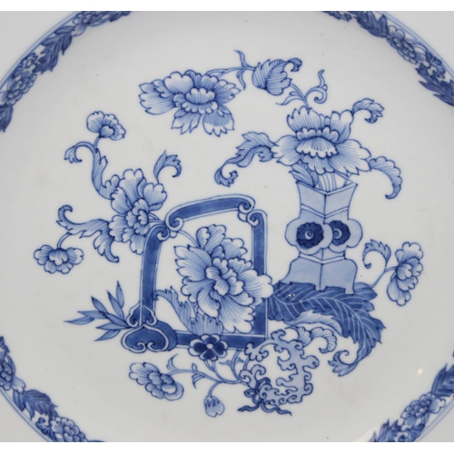 1658 - A large antique Chinese blue and white porcelain charger decorated with a scene of flowers and vases... 