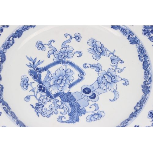 1658 - A large antique Chinese blue and white porcelain charger decorated with a scene of flowers and vases... 