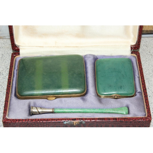 1022 - An early 20th century Coronet Series silver mounted cigarette holder with an early plastic green jad... 