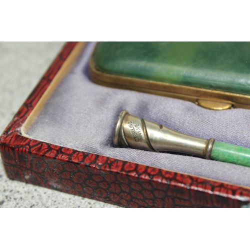 1022 - An early 20th century Coronet Series silver mounted cigarette holder with an early plastic green jad... 