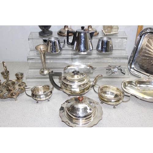 1024 - Qty of Antique and later silver plated items to include candlesticks and serving trays approx 7.2kg