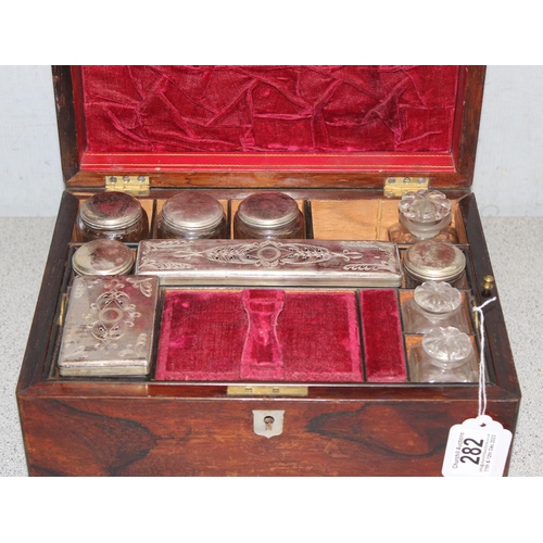 282 - Antique ladies travelling vanity case with silver plate and cut glass jars, red velvet interior appr... 