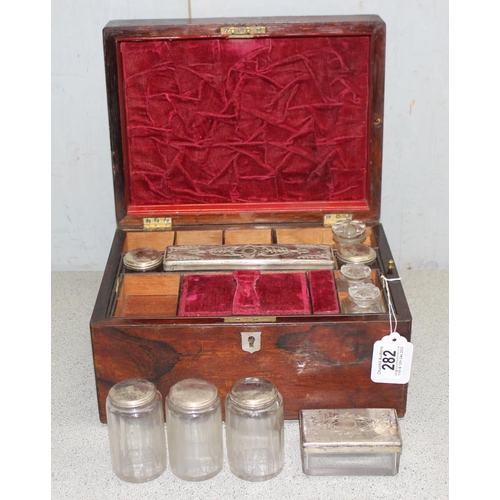 282 - Antique ladies travelling vanity case with silver plate and cut glass jars, red velvet interior appr... 