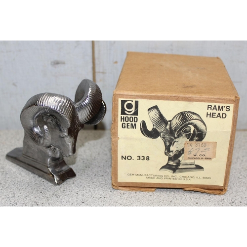 706 - Hood Gem Ram's head No. 338, seemingly unused in original box, and another in the form of a dancer o... 