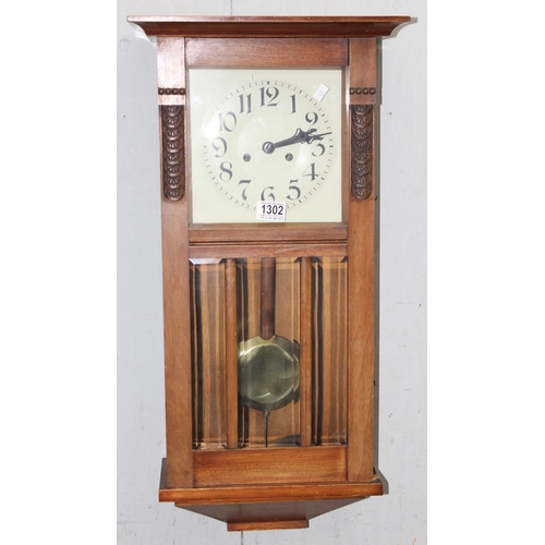 1302 - Art Deco period mechanical wall clock in mahogany case with pendulum and keys