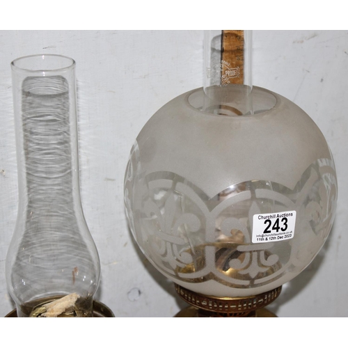 243 - Pair of vintage brass oil lamps to include one with frosted glass shade tallest approx. 49cm