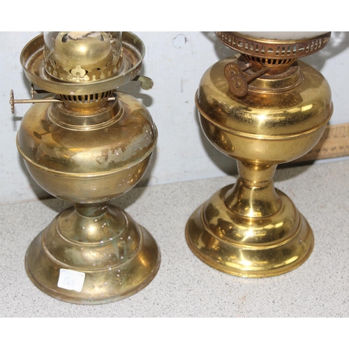 243 - Pair of vintage brass oil lamps to include one with frosted glass shade tallest approx. 49cm