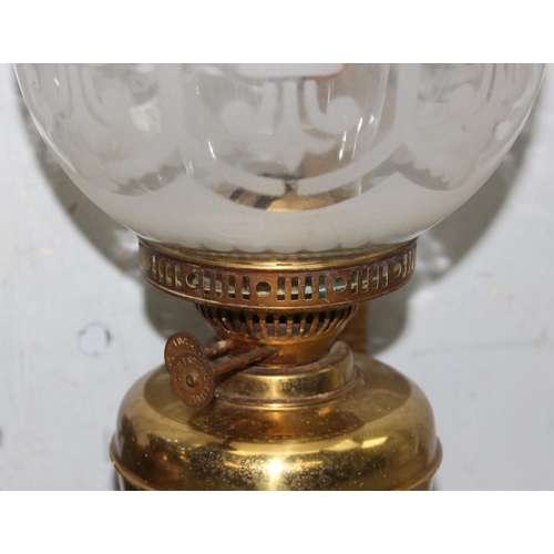 243 - Pair of vintage brass oil lamps to include one with frosted glass shade tallest approx. 49cm