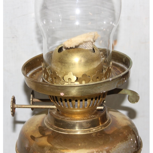 243 - Pair of vintage brass oil lamps to include one with frosted glass shade tallest approx. 49cm