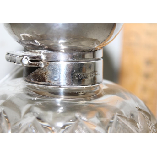 1007 - A silver topped and cut glass grenade shaped perfume bottle, Birmingham 1907 by M & C Lister Limited