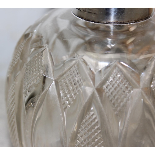 1007 - A silver topped and cut glass grenade shaped perfume bottle, Birmingham 1907 by M & C Lister Limited