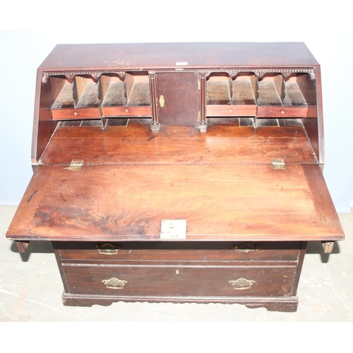 69 - An antique mahogany 4 drawer bureau with brass fittings, approx 97cm wide x 50cm deep x 97cm tall