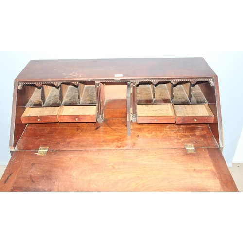 69 - An antique mahogany 4 drawer bureau with brass fittings, approx 97cm wide x 50cm deep x 97cm tall