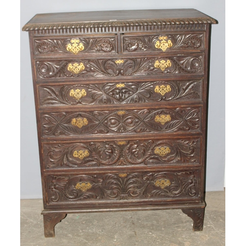 124 - An unusual antique 2 over 5 carved oak chest of drawers with brass fittings, approx 108cm wide x 54c... 