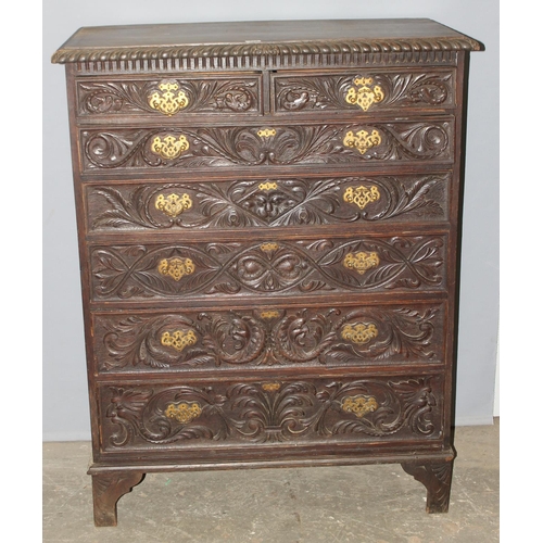 124 - An unusual antique 2 over 5 carved oak chest of drawers with brass fittings, approx 108cm wide x 54c... 